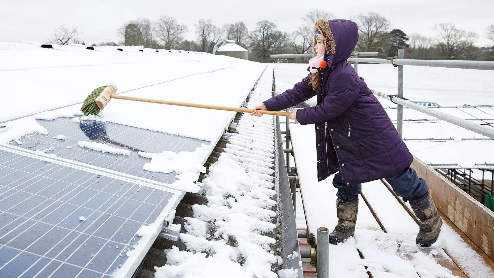 Clearing snow from solar panels at Grange Farm in the UK